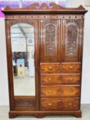 AN EDWARDIAN COMBINATION MAHOGANY WARDROBE (POOR CONDITION).
