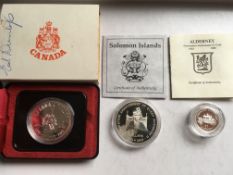 COINS: CANADA 1975 CALGARY SILVER DOLLAR IN CASE, SOLOMON ISLANDS 1992 $10 SILVER PROOF,