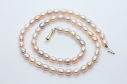 A CASED SET OF 'CLASSIQUE' PEARLS WITH CLASP MARKED 14K.