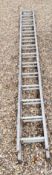A SET OF FOURTEEN TREAD ALUMINIUM DOUBLE EXTENSION LADDERS.