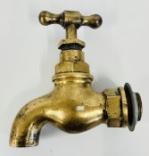A VINTAGE OVER SIZED BRASS TAP, HEIGHT 23CM.