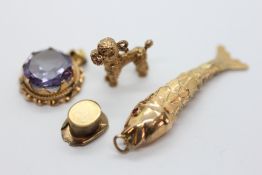 A YELLOW METAL FISH CHARM, ALONG WITH A 9CT GOLD TOP HAT CHARM A/F,
