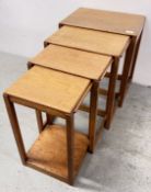 A GRADUATED SET OF FOUR TEAK OCCASIONAL TABLES.
