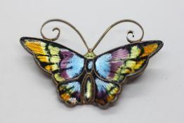 A DAVID ANDERSON NORWEGIAN SILVER GILT AND ENAMEL MULTI COLOURED BUTTERFLY BROOCH.