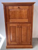 A GOOD QUALITY CHERRYWOOD DRINKS CABINET WITH CUPBOARD BASE AND FALL FRONT ABOVE,