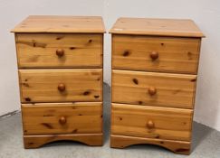A PAIR OF HONEY PINE 3 DRAWER BEDSIDE CHESTS.