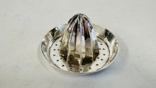 A WHITE METAL JUICER.