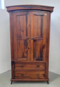 A PINE TWO DOOR WARDROBE ON TWO DRAWER BASE, W 112CM X D 64CM X H 200CM.