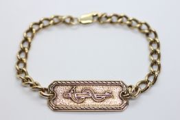 A 9CT GOLD MED-TAG ID TAG BRACELET BEARING INSCRIPTION.