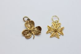 A YELLOW METAL FILIGREE CROSS PENDANT CHARM + A YELLOW METAL CLOVER LEAF PENDANT CHARM,