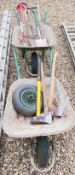 2 X BUILDERS WHEELBARROWS PLUS SPARE WHEEL ALONG WITH ASSORTED GARDEN TOOLS AND AXES.
