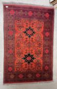AN EASTERN RED PATTERN CARPET, W 98CM X L 146CM.
