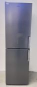 A GRUNDIG SILVER FINISH FRIDGE FREEZER - SOLD AS SEEN.