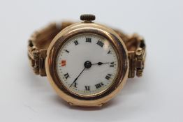 A VINTAGE 9CT GOLD CASED LADIES WRIST WATCH AND STRAP.