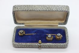 A VINTAGE YELLOW METAL TIE PIN AND STUD SET, INSET WITH A FLORAL GLASS PANEL.