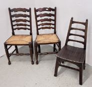 A PAIR OF OAK LADDER BACK SIDE CHAIRS WITH WOVEN RUSH SEATS ALONG WITH SINGLE OAK HALL CHAIR.