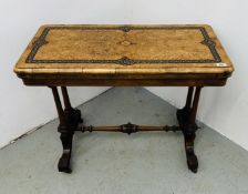 A VICTORIAN RECTANGULAR FOLDING GAMES TABLE ON TWIN END COLUMNS AND SPLAYED FEET,