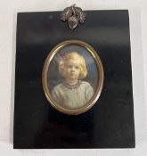 A MODERN OVAL PORTRAIT OF A BLOND GIRL FULL FACE,