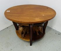 AN OVAL COFFEE TABLE IN SEPELE WOOD FITTED WITH FOUR SMALLER TABLES WITH ELEPHANT SUPPORTS, A/F.