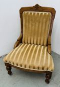 A VICTORIAN WALNUT FIRESIDE CHAIR IN OLD GOLD STRIPED DRALON.
