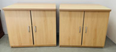 A PAIR OF MODERN BEECH FINISH TWO DOOR CUPBOARDS.