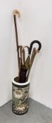 A CERAMIC STICK STAND DECORATED WITH FLORAL DESIGNS AND CONTENTS TO INCLUDE HORN HANDLED WALKING