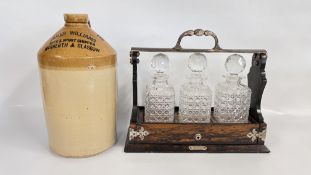 A VINTAGE ROSEWOOD FINISHED THREE BOTTLE TANTALUS BY MAPPIN & WEBB + A VINTAGE STONEWARE FLAGON