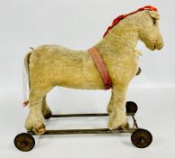 A VINTAGE SHIRE HORSE TOY ON WHEELS.