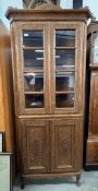 A HEAVILY CARVED HARD WOOD FLOOR STANDING CORNER CABINET WITH CUPBOARDS TO BASE, W 80CM, H 190CM.