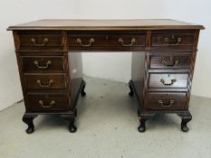 A MAHOGANY KNEEHOLE DESK WITH BROWN REXINE WRITING SURFACE,