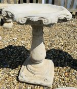 A CLASSICAL DESIGN STONEWORK BALUSTER DESIGN BIRD BATH WITH SCROLLED DETAIL AND OCTAGONAL TOP,