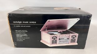 BOXED NOSTALGIC MUSIC CENTRE WITH CD, CASSETTE, RECORD AND RADIO - SOLD AS SEEN.