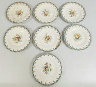 A MATCHED SET OF 7 HAND PAINTED FLORAL GILDED PLATES, BEARING IMPRESSED REGISTRATION MARKS.