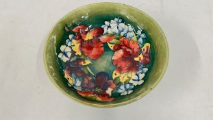 A MOORCROFT ORCHID PATTERN CIRCULAR BOWL, DIAMETER 22CM, SIGNED.