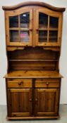 A HONEY PINE 2 DOOR 2 DRAWER DRESSER WITH GLAZED TOP.