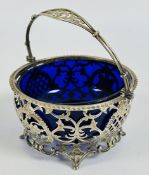 AN ANTIQUE SILVER PIERCED OPEN WORK SUGAR BASKET WITH BLUE GLASS LINER, LONDON 1903,