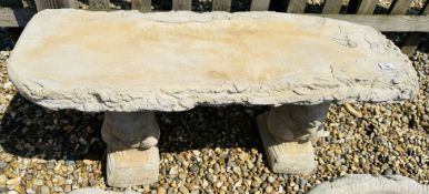 A WOODLAND DESIGN STONEWORK GARDEN BENCH, THE SEAT SUPPORTED BY SQUIRRELS, LENGTH 100CM.