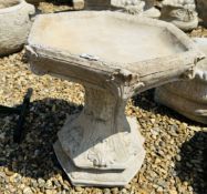 A CLASSICAL DESIGN HEXAGONAL STONEWORK GARDEN BIRD BATH WITH ACANTHUS LEAF DECORATION, HEIGHT 44CM.