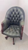 A BOTTLE GREEN BUTTON BACK CHESTERFIELD STYLE REVOLVING OFFICE CHAIR - TRADE SALE ONLY.