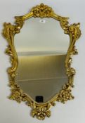 AN ELABORATE MODERN GILT FRAMED WALL MIRROR DECORATED WITH SCROLLS AND FLOWERS, H 75CM.