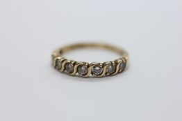 A 9CT YELLOW GOLD SEVEN STONE CZ SET DRESS RING.