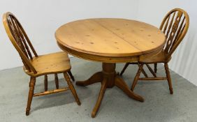 A CIRCULAR HONEY PINE SINGLE PEDESTAL EXTENDING BREAKFAST / DINING TABLE WITH TWO CHAIRS.