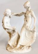 AN ANTIQUE FRENCH SERVES STYLE BISQUE PORCELAIN SCULPTURE DEPICTING TWO FIGURES ENTANGLED IN FLORAL