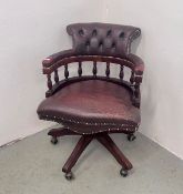 AN OXBLOOD LEATHER CAPTAINS STYLE REVOLVING OFFICE CHAIR - TRADE SALE ONLY.