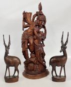 A HAND CARVED WOODEN STATUE, DEPICTING A HINDU DEITIE, H 58CM + A PAIR OF CARVED ANTELOPE, H 38CM.