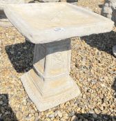 A SQUARE STONEWORK GARDEN BIRD BATH WITH ROSE DECORATION, HEIGHT 49CM.