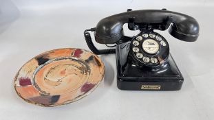 A VINTAGE BELL TELEPHONE MARKED MFG COMPANY AND A GLAZED STUDIO POTTERY PLATE BEARING IMPRESSED
