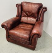 A TAN LEATHER EASY CHAIR.