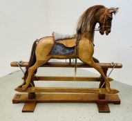 A MODERN MAHOGANY ROCKING HORSE MANUFACTURED BY STEVENSON BROTHERS S/N 3145 DATED 1998.