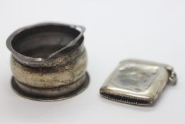 A SILVER VESTA CASE (MIS-SHAPEN) + SILVER NAPKIN RING.